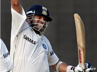 Sachin Tendulkar celebrates his century and win over England during the first Test match between India and England in Chennai.